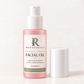 RENATURALS Bakuchiol + Vanilla Facial Oil, 1 fl oz (30 mL), in a pink frosted bottle with a white pump and Botanical R label, with the white protective overcap beside it on warm ivory.