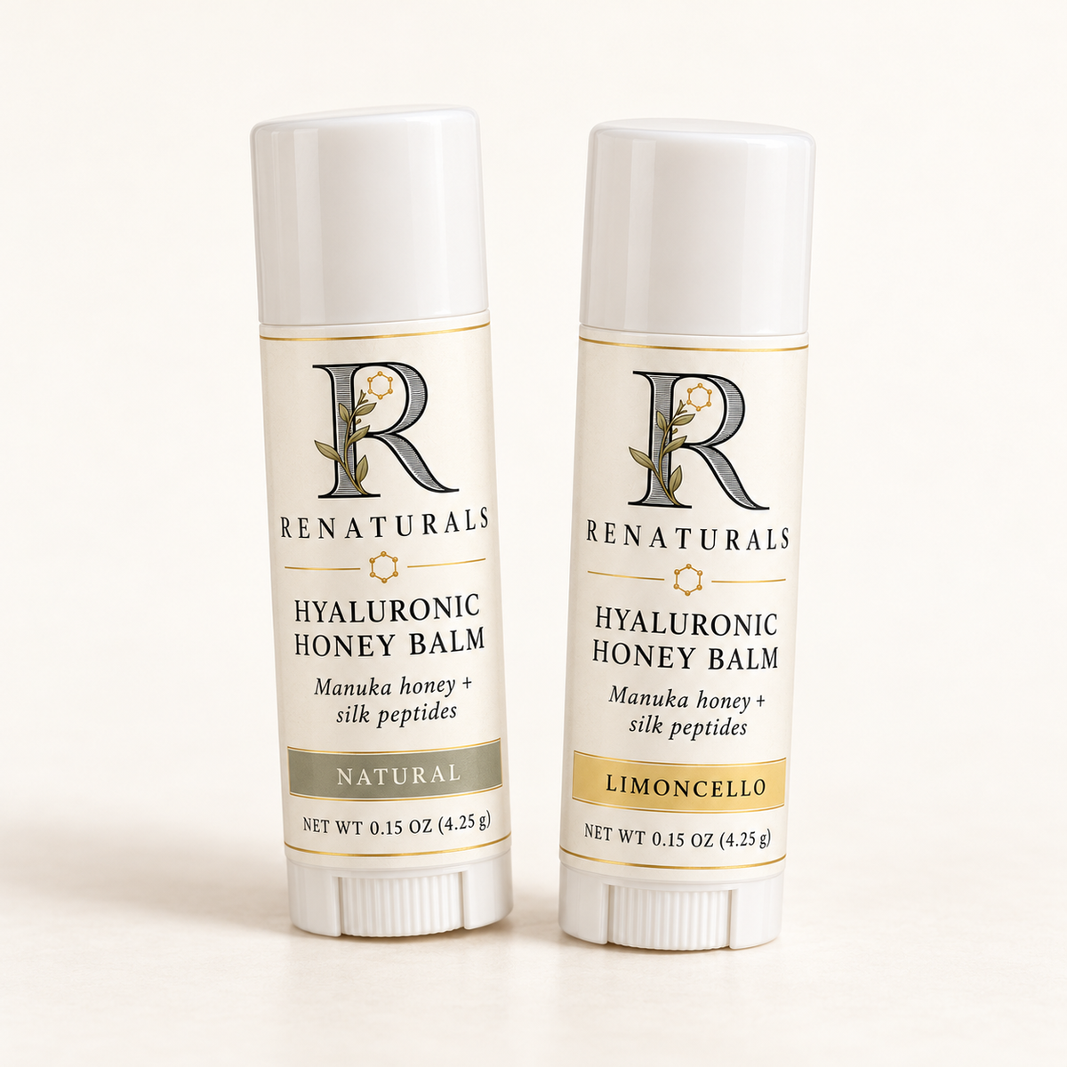 RENATURALS Hyaluronic Honey Balm, Natural and Limoncello, in white 0.15 oz lip balm sticks with Botanical R and gold-trim ivory labels.