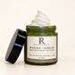 RENATURALS Manuka + Vanille Whipped Body Butter, 4oz, showing its whipped cream texture in an open green glass jar with the black lid beside it and a gold-trim Botanical R label on ivory.