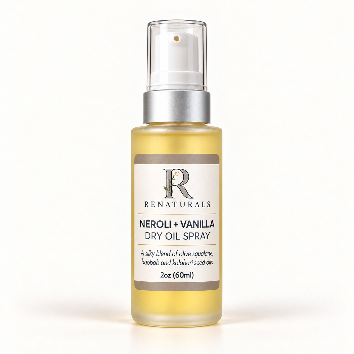 RENATURALS Neroli + Vanilla Dry Oil Spray, 2oz (60ml), in a tall clear frosted bottle with golden oil, matte-silver sleeve, white spray tip, clear overcap and Botanical R label on ivory.