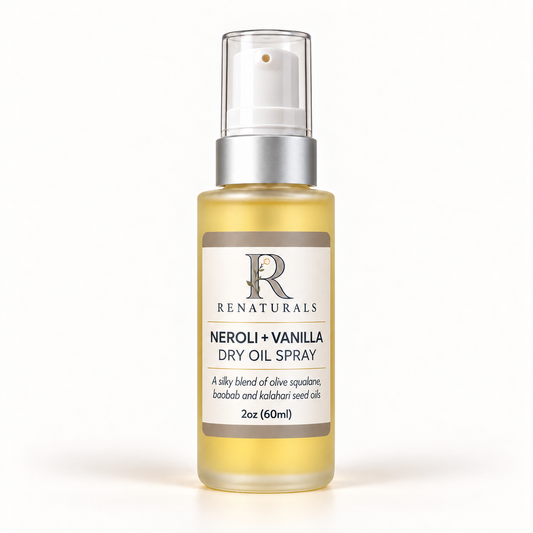 RENATURALS Neroli + Vanilla Dry Oil Spray, 2oz (60ml), in a tall clear frosted bottle with golden oil, matte-silver sleeve, white spray tip, clear overcap and Botanical R label on ivory.