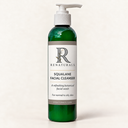 RENATURALS Squalane Facial Cleanser in a green bottle with a white pump and an ivory, taupe and soft-gold Botanical R label on an ivory background.