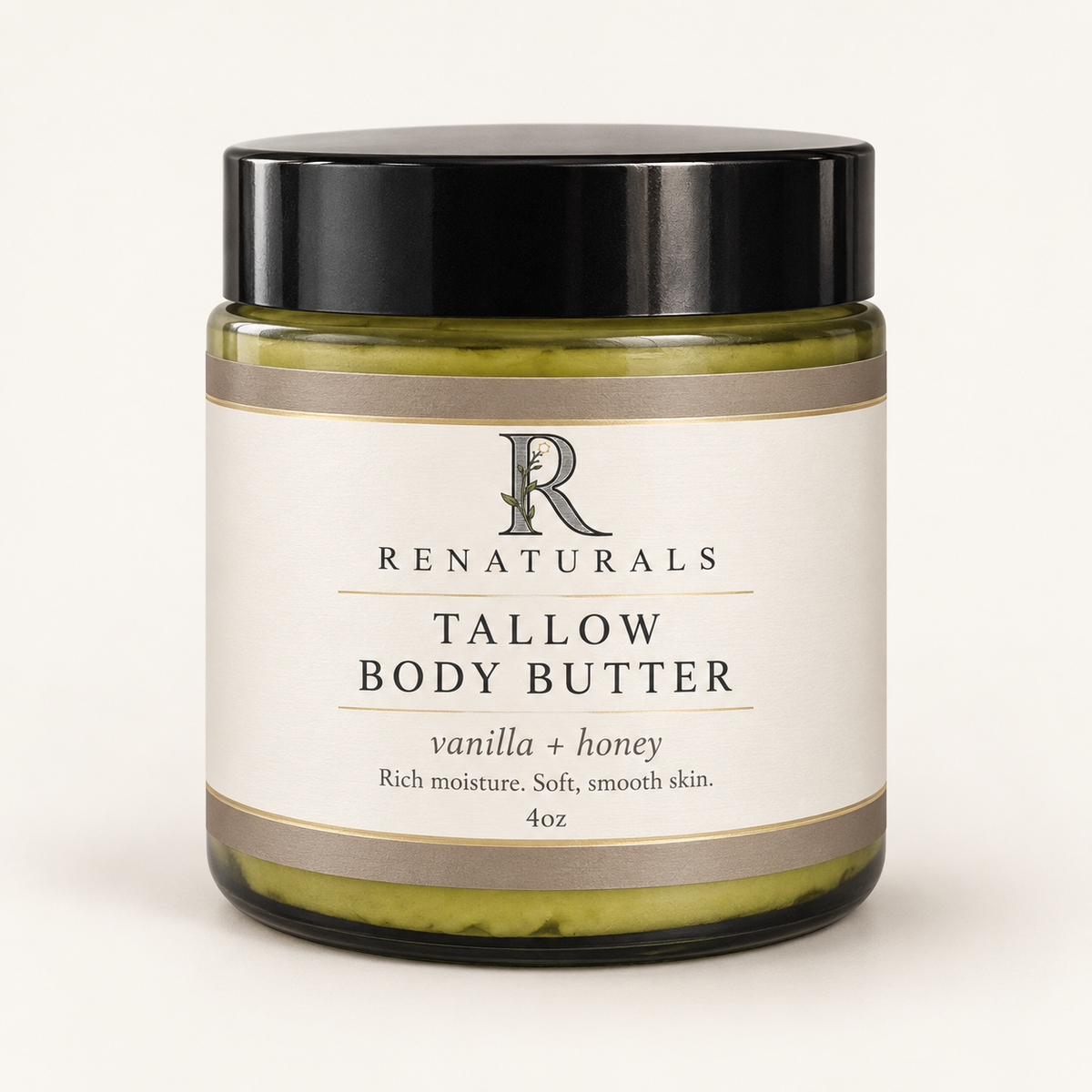 RENATURALS Vanilla + Honey Tallow Body Butter, 4oz, in a green glass jar with a black lid and ivory, taupe and gold-trim Botanical R label on an ivory background.