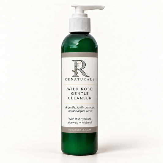 RENATURALS Wild Rose Gentle Cleanser in a green bottle with a white pump and an ivory, taupe and soft-gold Botanical R label on a smooth ivory background.